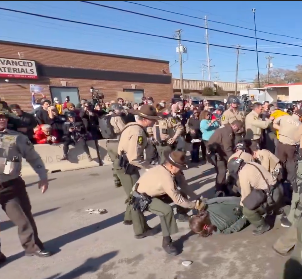 Cop and Protester Cleaning Streets